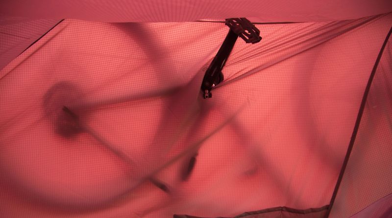 Silhouette of a bike showing through the fly, seen from inside the tent
