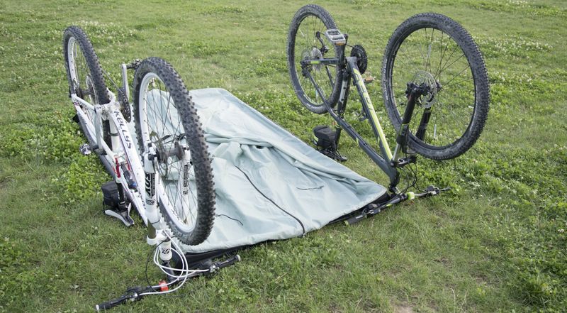 Two bikes turned upside down with the inner tent laid out between them